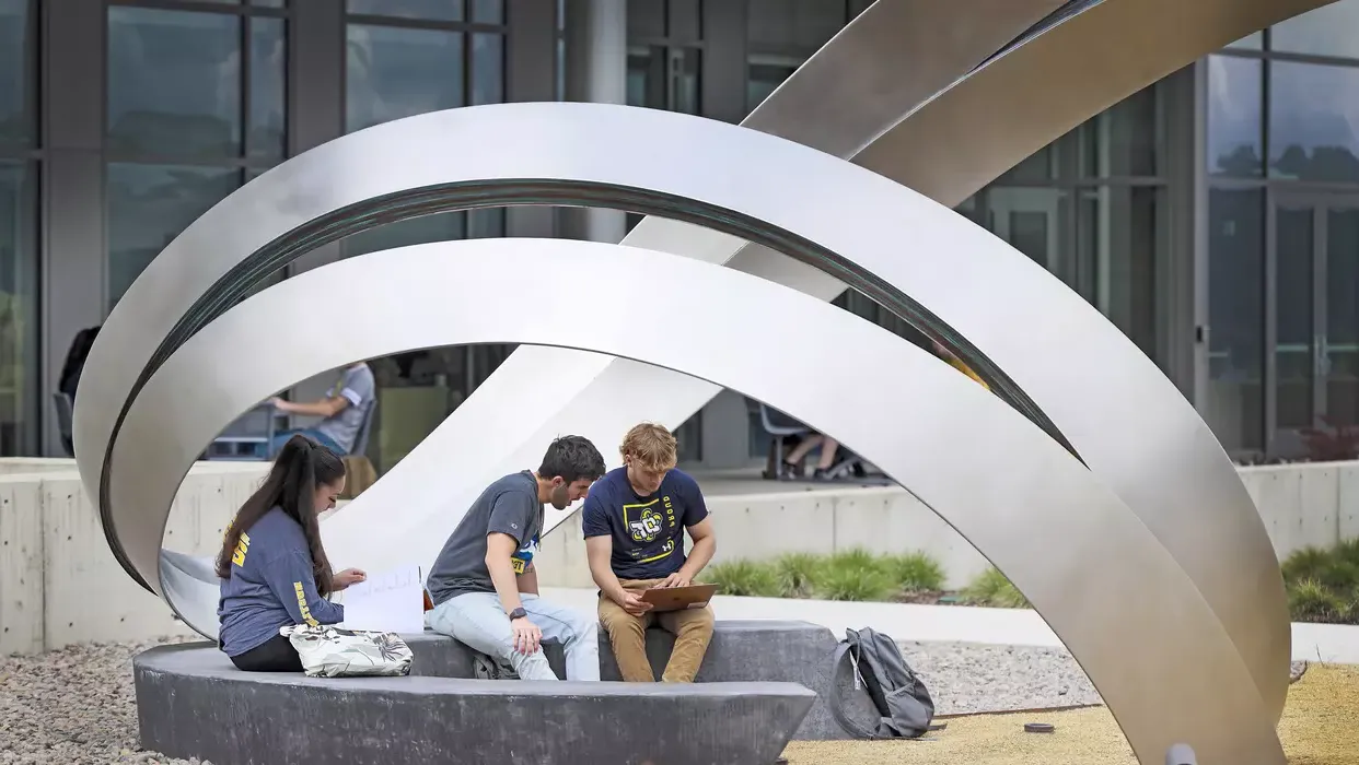 Students sitting at Moment Sculpture